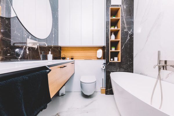 Modern new luxury bathroom. Interior design with marble, wood and stainless steel